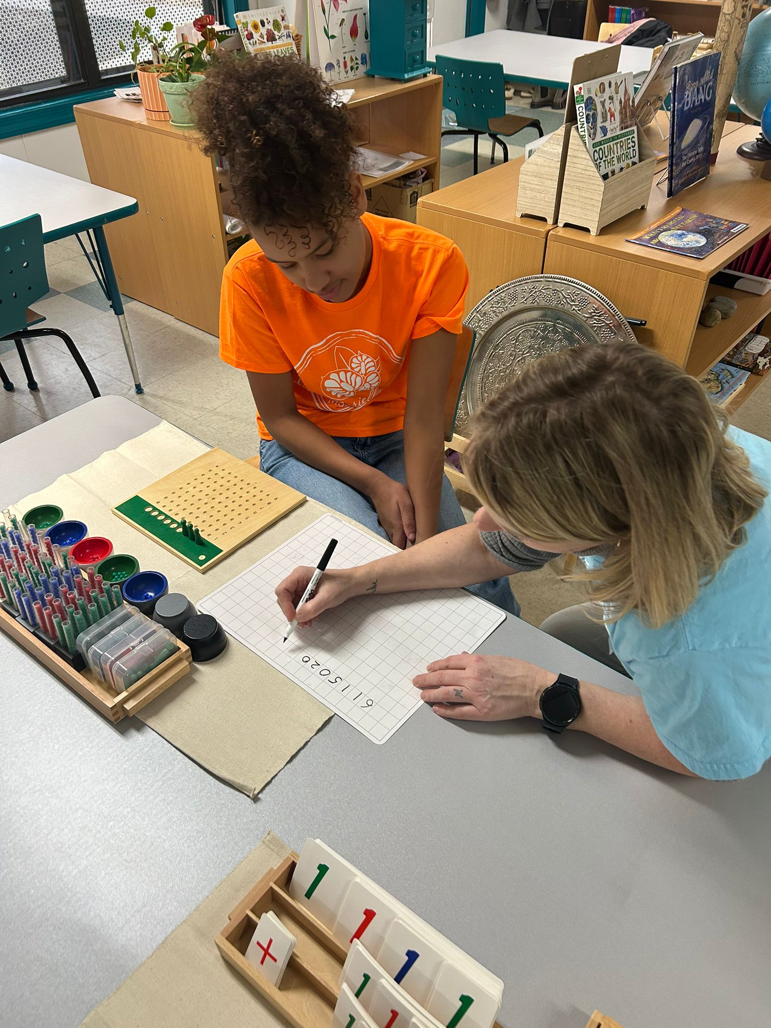 Teacher guiding student through math activity